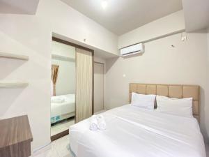 Spacious and Homey 2BR Apartment at Newton Residence By Travelio