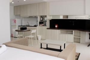 Comfort and Minimalist Studio at Azalea Suites Apartment By Travelio
