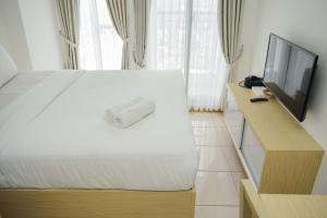 High Floor and Minimalist Studio Room at M-Town Residence Apartment By Travelio