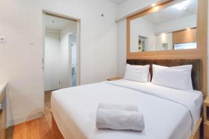 Minimalist and Homey Studio at Amartha View Apartment By Travelio