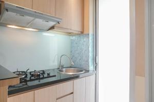 Fully Furnished with Elegant Design 2BR Bassura City Apartment By Travelio