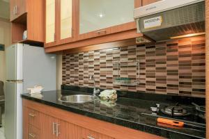 Homey and Compact 2BR Mediterania Marina Ancol Apartment By Travelio