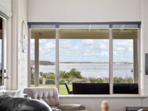 Pelicans View a Riverside Retreat