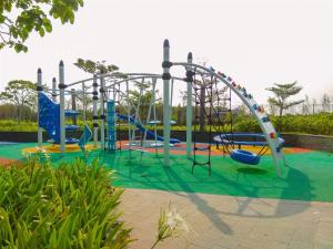 Nice and Homey 1BR at Gold Coast Apartment By Travelio