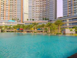 Nice and Homey 1BR at Gold Coast Apartment By Travelio