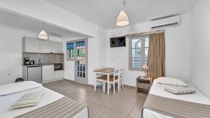 Junior Suite (Quadruple) Bedroom & Living Room room in Evina Rooms & Suites