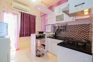 Homey 1BR with Spacious Living Room Green Pramuka City Apartment By Travelio
