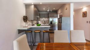 Elegant Condo with Brand-New Fixtures, Shaded Tropical Terrace, and Secluded Beach Access