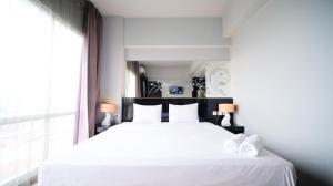 Homey Studio No Kitchen at Grand Darmo Suite Apartment By Travelio