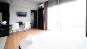 Homey Studio No Kitchen at Grand Darmo Suite Apartment By Travelio