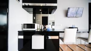 Homey Studio No Kitchen at Grand Darmo Suite Apartment By Travelio