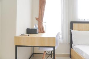 Minimalist and Homey Studio at Evenciio Margonda Apartment By Travelio