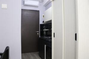 Minimalist Studio at Grand Asia Afrika Apartment By Travelio