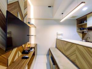 Fancy and Nice 1BR with Extra Room at Amartha View Apartment By Travelio