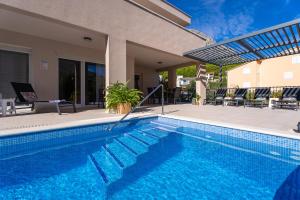 Villa Leonore in Omis with 4 en-suite bedrooms, heated pool, PS5, completely fenced yard & just 3 mi 
