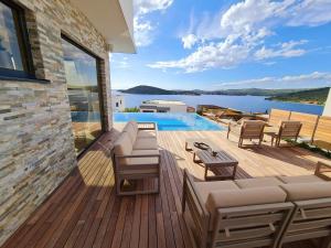 Villa Ramarin III with infinity heated pool, jacuzzi and sauna by the sea in Rogoznica