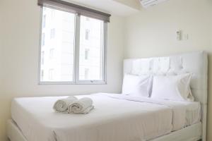 Stunning and Comfy 2BR Bassura City Apartment By Travelio