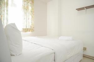 Nice and Modern 2BR at Green Pramuka City Apartment By Travelio