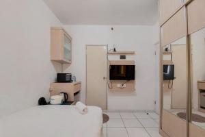 Cozy and Minimalist Studio (No Kitchen) at Aeropolis Apartment By Travelio