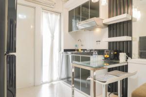 Comfort Living and Minimalist 1BR at Bassura City Apartment By Travelio