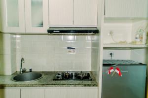 Homey and Warm Studio Room at Tifolia Apartment By Travelio