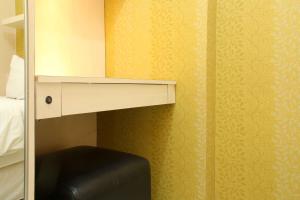 Minimalist and Warm 2BR Bassura City Apartment By Travelio