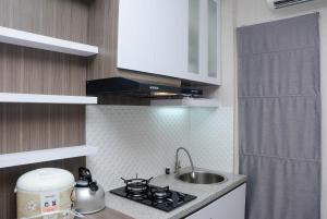 Cozy Stay 2BR Bassura City Apartment near Mall By Travelio