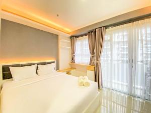 Cozy and Homey 1BR at Gateway Pasteur Apartment By Travelio