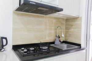 Homey and Cozy 2BR Bassura City Apartment near Mall By Travelio