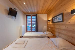 Appartements l-Ours Bleu B01 - Ski in Ski out - Happy Rentals : photos des chambres
