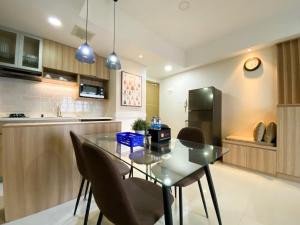 Cozy and Minimalist 2BR at 8th Floor The Oasis Cikarang Apartment By Travelio