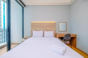 Modern and New 1BR across LRT Station Samara Suites Apartment By Travelio