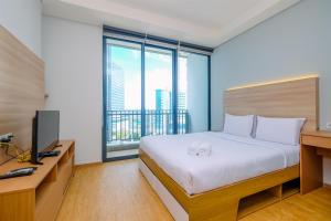 Modern and New 1BR across LRT Station Samara Suites Apartment By Travelio