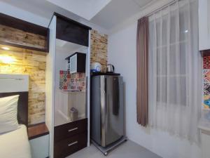 Simple and Homey Studio Room at Paltrow City Apartment By Travelio