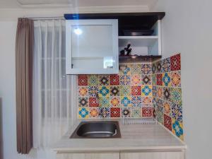 Simple and Homey Studio Room at Paltrow City Apartment By Travelio