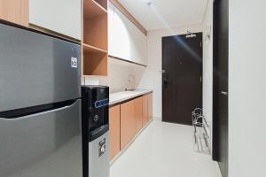 Homey Studio at Patraland Amarta Apartment By Travelio