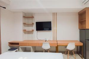 Homey Studio at Patraland Amarta Apartment By Travelio