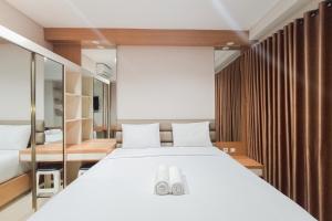 Homey Studio at Patraland Amarta Apartment By Travelio