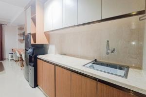 Homey Studio at Patraland Amarta Apartment By Travelio