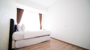 3BR with Private Lift Connected to Mall Grand Sungkono Lagoon Apartment By Travelio