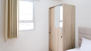 Homey 2BR at Puncak Permai Apartment By Travelio