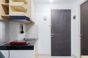 Fully Furnished 1BR with Study Room at Serpong Garden Apartment By Travelio