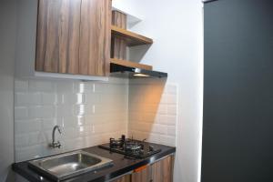 Elegant and Comfy Studio at Bassura City Apartment By Travelio