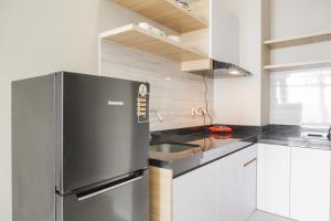 Minimalist and Comfort Living 1BR at Ciputra International Apartment By Travelio