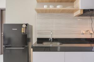 Minimalist and Comfort Living 1BR at Ciputra International Apartment By Travelio