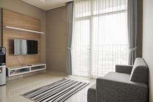 Minimalist and Comfort Living 1BR at Ciputra International Apartment By Travelio