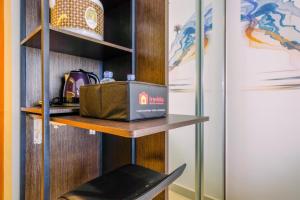 Cozy Stay and Tidy Studio at Evenciio Margonda Apartment By Travelio