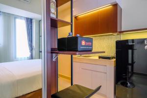 Restful and Tidy Studio at Evenciio Margonda Apartment By Travelio