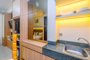 Homey and Stylish Studio Room at Transpark Cibubur Apartment By Travelio