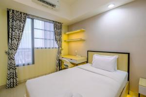 Comfy and Minimalist Studio at Evenciio Margonda Apartment By Travelio